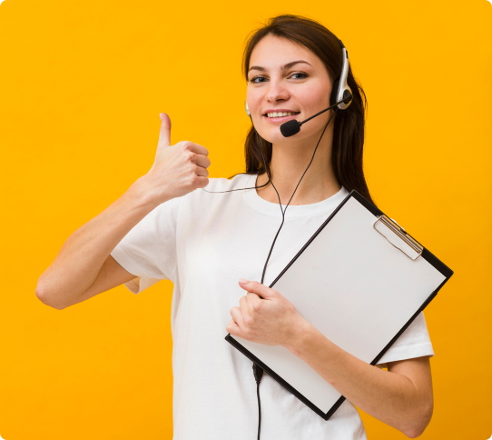 A woman with headphones holding a clipboard and giving thumbs up.